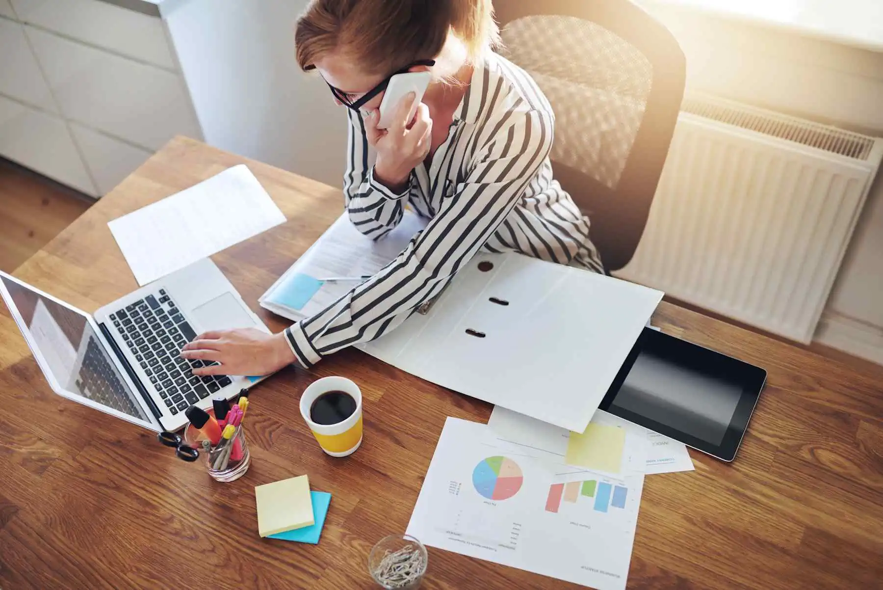 a background image of woman working at her desk, following a successful website launch